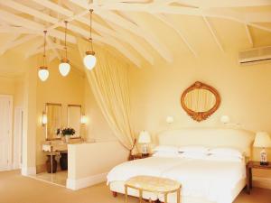 a bedroom with a white bed and a mirror at Colona Castle in Lakeside +73 photos