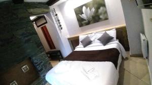a bedroom with a large bed with white sheets and pillows at Villa Azur Cap d'Ail in Cap d'Ail