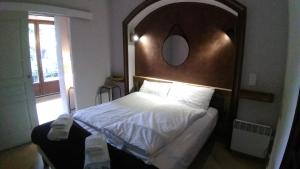 a bedroom with a large bed with a wooden headboard at Villa Azur Cap d'Ail in Cap d'Ail
