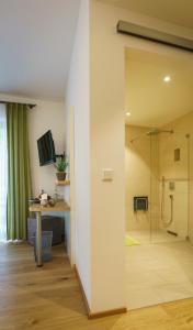 a bathroom with a shower and a table and a desk at Hotel-Gasthof zur Sonne in Pappenheim