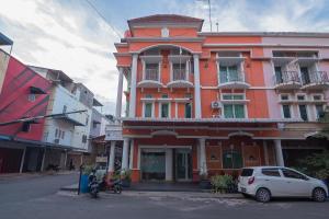 a white car parked in front of a building at RedDoorz @ Batam Center 2 in Batam Center