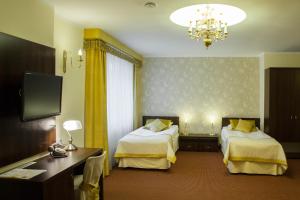 a hotel room with two beds and a television at Hotel Ostrawa in Wodzisław Śląski +33 photos