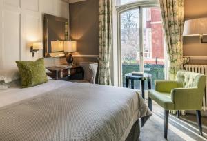 a hotel room with a bed and a window at 11 Cadogan Gardens and The Apartments in London