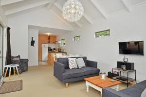 a living room with a couch and a table at The Escape in Martinborough