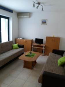 a living room with a couch and a coffee table at APARTMAN KOREN in Malinska