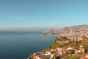 an aerial view of a town next to the ocean at Ocean Gardens in Funchal