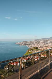 a view of a city and the ocean from a balcony at Ocean Gardens in Funchal
