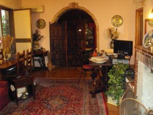 a living room with a table and a desk at Villa La Spada in Taormina