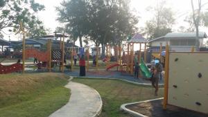 a park with a playground with people playing on it at Tropicana Home Concept @ Wabest, KLIA in Sepang