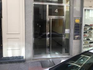 a glass revolving door on the side of a building at VIVIENDAS DELUXE Gil y Carrasco in León