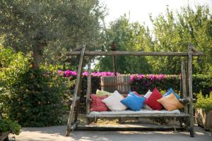 a bench filled with colorful pillows in a garden at Hotel Al Mulino in Anacapri