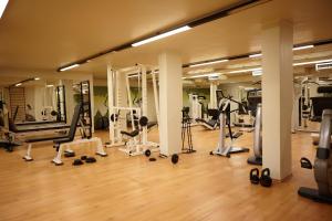 a gym with several treadmills and machines in it at Lo Chalet in Castione della Presolana