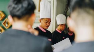 a group of chefs standing in front of a mirror at Villa Wat Damnak in Siem Reap