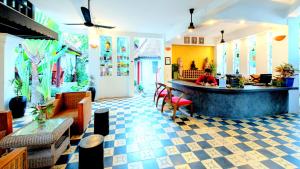 a lobby of a restaurant with a person sitting at a counter at VILLA WAT DAMNAk in Siem Reap