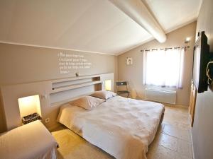 a bedroom with a white bed and a window at Superb villa with private pool in Apt