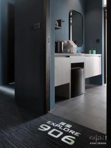 a bathroom with a sink and a mirror at Explore Hotel in Taichung