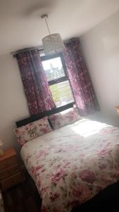 a bedroom with a bed and a window at The West House in Belmullet