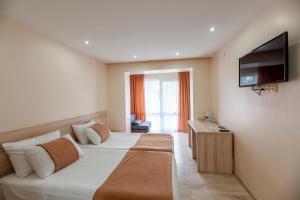 מיטה או מיטות בחדר ב-Kolkhida Resort & Spa