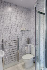 a bathroom with a toilet and a glass shower at Ford Down Farm B&B in South Molton
