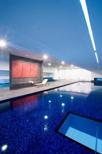 a large swimming pool with a glass ceiling at Fraser Suites Sydney in Sydney