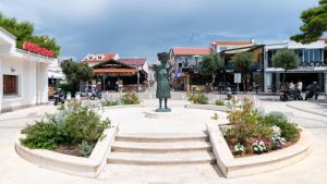 a statue in the middle of a town square at Holiday Home Darko in Novalja