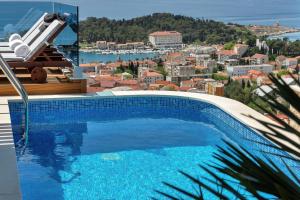 a swimming pool with a view of a city at Villa Afrodita in Makarska