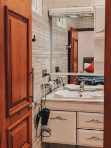 a bathroom with a sink and a mirror at Pinnacle boutique villas in Galle