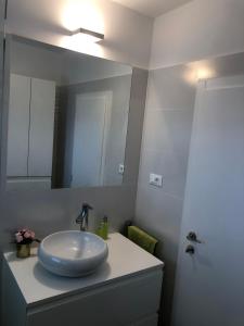 a bathroom with a sink and a mirror at Apartments Don in Vantačići