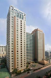 a tall white building with the asot sign on it at Ascott Jakarta in Jakarta