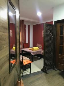 a dressing room with a mirror and two beds at Coin Du Repôs in Oujda