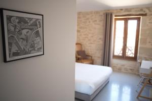 Postel nebo postele na pokoji v ubytování Hôtel Le 23