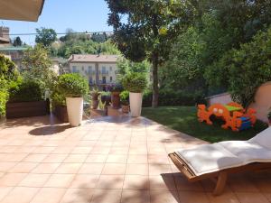 a patio with a lawn with chairs and a toy at B&B La Casa di Rita in Porto San Giorgio
