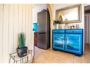 a blue cabinet in a kitchen with a refrigerator at Villa Mikula in Maslinica