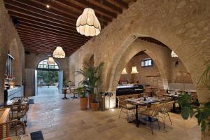 a restaurant with tables and chairs in a stone building at Polis 1907 by Louis Hotels in Polis Chrysochous