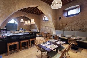 a restaurant with tables and chairs in a stone building at Polis 1907 by Louis Hotels in Polis Chrysochous