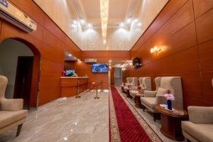 a waiting room with chairs and a red carpet at Jasmine Beach Hotel Suites in Yanbu
