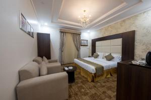 a hotel room with a bed and a couch at Jasmine Beach Hotel Suites in Yanbu