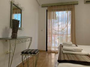 a room with a bed and a mirror and a window at Sea Side in Kakovatos