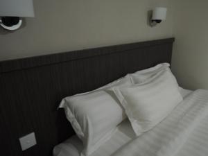 Postel nebo postele na pokoji v ubytování Harlys Residence