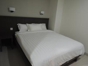 Postel nebo postele na pokoji v ubytování Harlys Residence