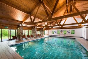 a swimming pool with a large tub in the middle of it at Chevin Country Park Hotel & Spa in Otley