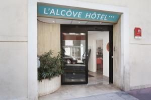 a door to a luxury hotel with a sign on it at Hôtel Alcôve Nice in Nice