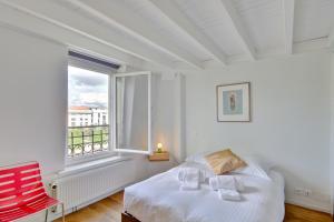 a bedroom with a bed and a large window at l'Etoile by Cocoonr in Bordeaux