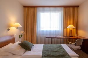 Postel nebo postele na pokoji v ubytování Globana Airport Hotel