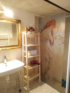 a bathroom with a sink and a painting on the wall at Dimora Santa Maria in Putignano