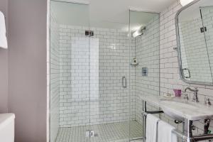 
a bathroom with a shower, sink, and toilet at Clinton Hotel South Beach in Miami Beach
