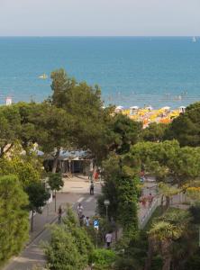 a view of a beach with people and the ocean at Hotel Astro in Lignano Sabbiadoro