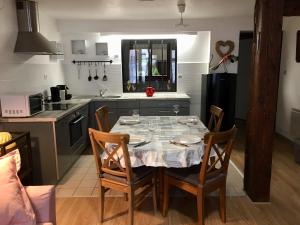 a kitchen with a table and chairs in a kitchen at l’Atelier in Sélestat