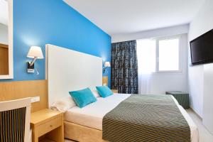 Кровать или кровати в номере Universal Hotel Marqués