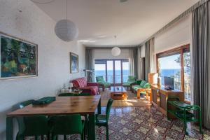 a living room with a table and chairs and a television at Stunning View- Wifi & Parking in Villa Solari